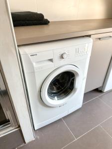 a white washer and dryer in a kitchen at Charmant duplex en centre-ville in Brive-la-Gaillarde