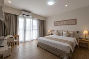 Postel nebo postele na pokoji v ubytování Kantary Hotel Banchang