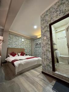 a bedroom with a large bed and a bathroom at 8848 Hostel in Kathmandu