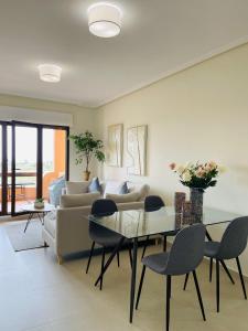 a living room with a couch and a table and chairs at Casa Michella - Golf and Seaview & Pet-Friendly in Los Alcázares