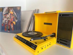 a yellow radio with a cd on top of it at AMAZING Beach View Apartment type 28 in Ostend