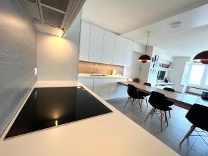 a kitchen with a table and chairs in a room at AMAZING Beach View Apartment type 28 in Ostend