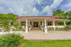 a house with a staircase in front of it at ama Stays & Trails Palmeira De Socorro , Goa in Old Goa