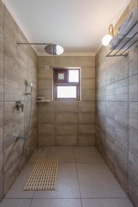 La grande salle de bains est pourvue d'une douche et d'une fenêtre. dans l'établissement ama Stays & Trails Palmeira De Socorro , Goa, à Vieux-Goa