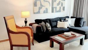 a living room with a blue couch and a table at Luxury Apartment in Kaduwela