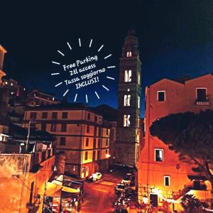 a view of a city with a clock tower at night at CAIETA Housing in Gaeta