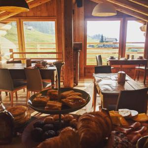 a room with a table with bread and pastries on it at Lavarets Chambres d’Hôtes in Ayas