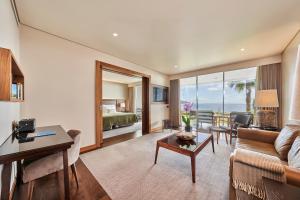 a living room with a couch and a table at Les Suites at The Cliff Bay - PortoBay in Funchal