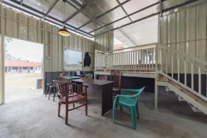 a room with chairs and a table in a barn at Pondok Hefi Ciwidey RedPartner in Ciwidey