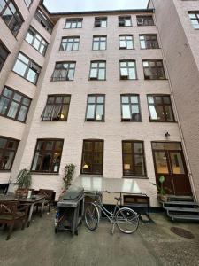a bike parked in front of a building at PSG 23 - Short Stay Apartments by Living Suites in Copenhagen