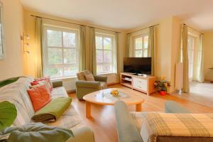 a living room with a couch and a table at Jägerstrasse 7 Ferienwohnung 8 in Kölpinsee
