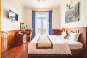 Postel nebo postele na pokoji v ubytování Dieu Thong Hotel