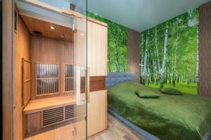 a bedroom with a bed and a window with trees at Apartament River Towers in Bydgoszcz