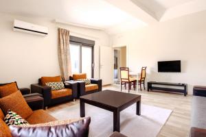 a living room with a couch and a table at Nature View Flat w Terrace 5 min to Beach in Kemer in Antalya
