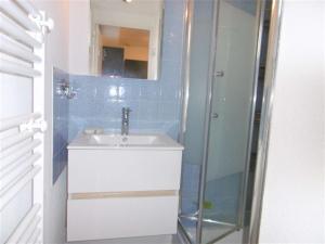 a bathroom with a sink and a glass shower at Maisonnette JIKEL à 50 m de la plage in Sarzeau