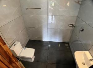 a bathroom with a toilet and a sink at Mahout Resort Wayanad - An Experiential Jungle Stay with Waterfall in Kalpetta