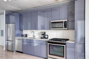 a kitchen with stainless steel appliances and a microwave at River North 1br w gym pool roof nr Riverwalk CHI-825 in Chicago
