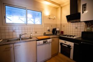 a small kitchen with a sink and a window at La Forêt Mountain views Parking in Font-Romeu-Odeillo-Via