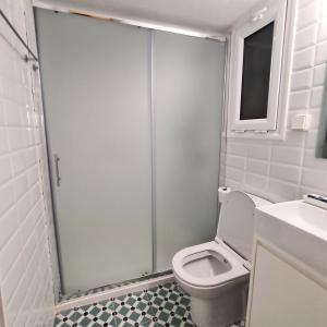 a bathroom with a shower with a toilet and a sink at Artistic Abode I Work-Friendly in Athens