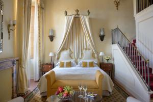 a bedroom with a large bed with a canopy at Grand Hotel Continental Siena - Starhotels Collezione in Siena