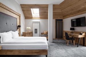 a hotel room with a bed and a desk at Aparthotel Cristina in Zakopane