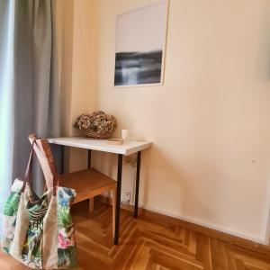 a small table in a room with a chair at Artistic Abode I Work-Friendly in Athens