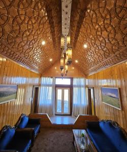a room with two chairs and a table and a window at Gulmarg Woods By Stay Pattern in Gulmarg