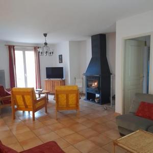 a living room with a couch and a fireplace at Gites du Quié in Les Cabannes