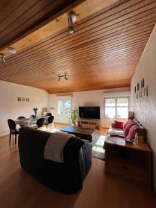 a living room with a couch and a table at Logement avec vue panoramique à 10min des pistes in Sauto