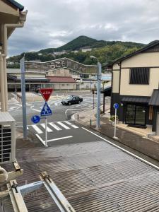 a parking lot with a street sign in a city at わがらん家 -えんつなぎ- in Kumano