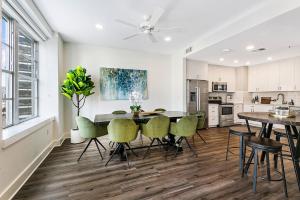 a kitchen and dining room with a table and chairs at Spacious Luxury 4BR Condo Moments from French Quarter in New Orleans