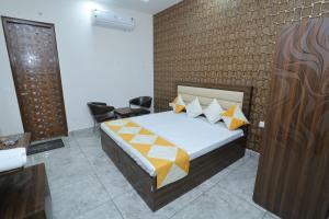 a bedroom with a bed and a brick wall at Raghav inn in Karnal