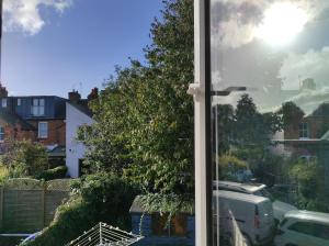 a glass window with a view of a street at Osney Juniper Studio - Self Contained Studio Flat in Oxford