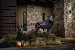 a statue of two gazelles in front of a building at Oryx Boutique Hotel in Klerksdorp