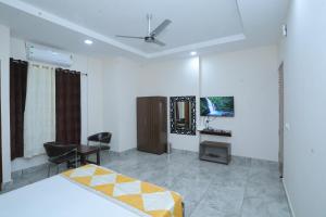 a bedroom with a bed and a desk and a table at Raghav inn in Karnal