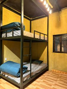 a room with three bunk beds in it at Maison de Hill Home in Dồng Văn