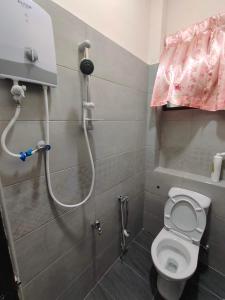 a small bathroom with a shower with a toilet at CLP perai homestay near Sri Muniswarar Temple 2 in Perai +7 photos