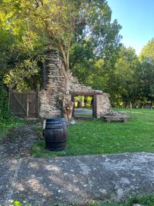 un edificio de piedra con un árbol y un barril en The Garden by LUKE en Ezcaray