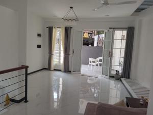 a living room with white walls and a ceiling at Kurumba Holidays Srilanka in Galle