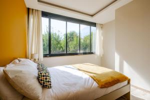 a bedroom with a bed and a large window at Chic Flat w Garden Nature View in Kemer in Antalya
