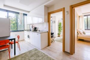 a kitchen with a washer and dryer in a room at Chic Flat w Garden Nature View in Kemer in Antalya