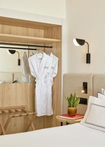 a room with a white robe hanging on a closet at Meliá Lloret de Mar in Lloret de Mar