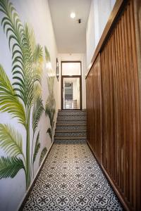 a hallway with a mural of plants on the wall at Casa Mercedes in Panama City