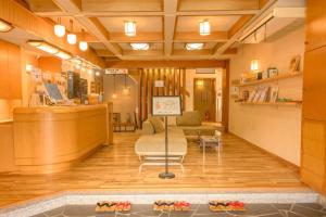 a lobby with a waiting area with shoes on the floor at Shibu Onsen KADOYA in Yamanouchi