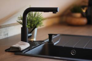 a kitchen sink with a faucet on a counter at Connemara luxury apartment in Kinvara
