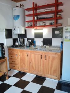 a kitchen with a sink and a counter top at El Valle Hostería in Mina Clavero