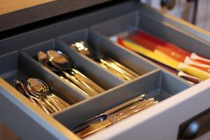 a tray of utensils in a drawer at Connemara luxury apartment in Kinvara