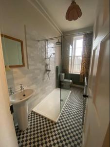 a bathroom with a glass shower and a sink at Thirsk Hall South Wing, North Yorkshire in Thirsk