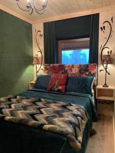 a bedroom with a large bed and a window at Apartament Zielony by Homeprime in Bukowina Tatrzańska