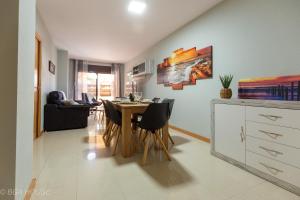 a kitchen and dining room with a table and chairs at Bga Rentals Garbi in Cambrils